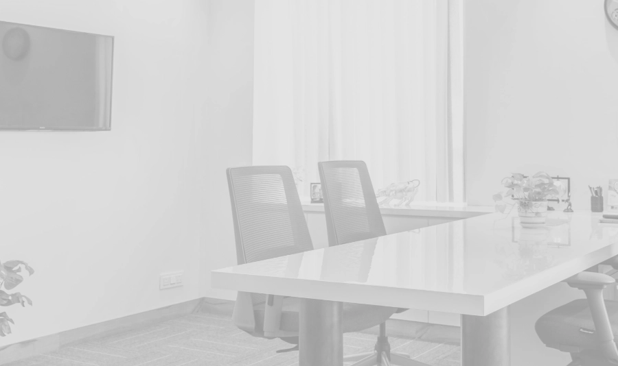 Black and white image of two chairs sitting at a desk in a modern office